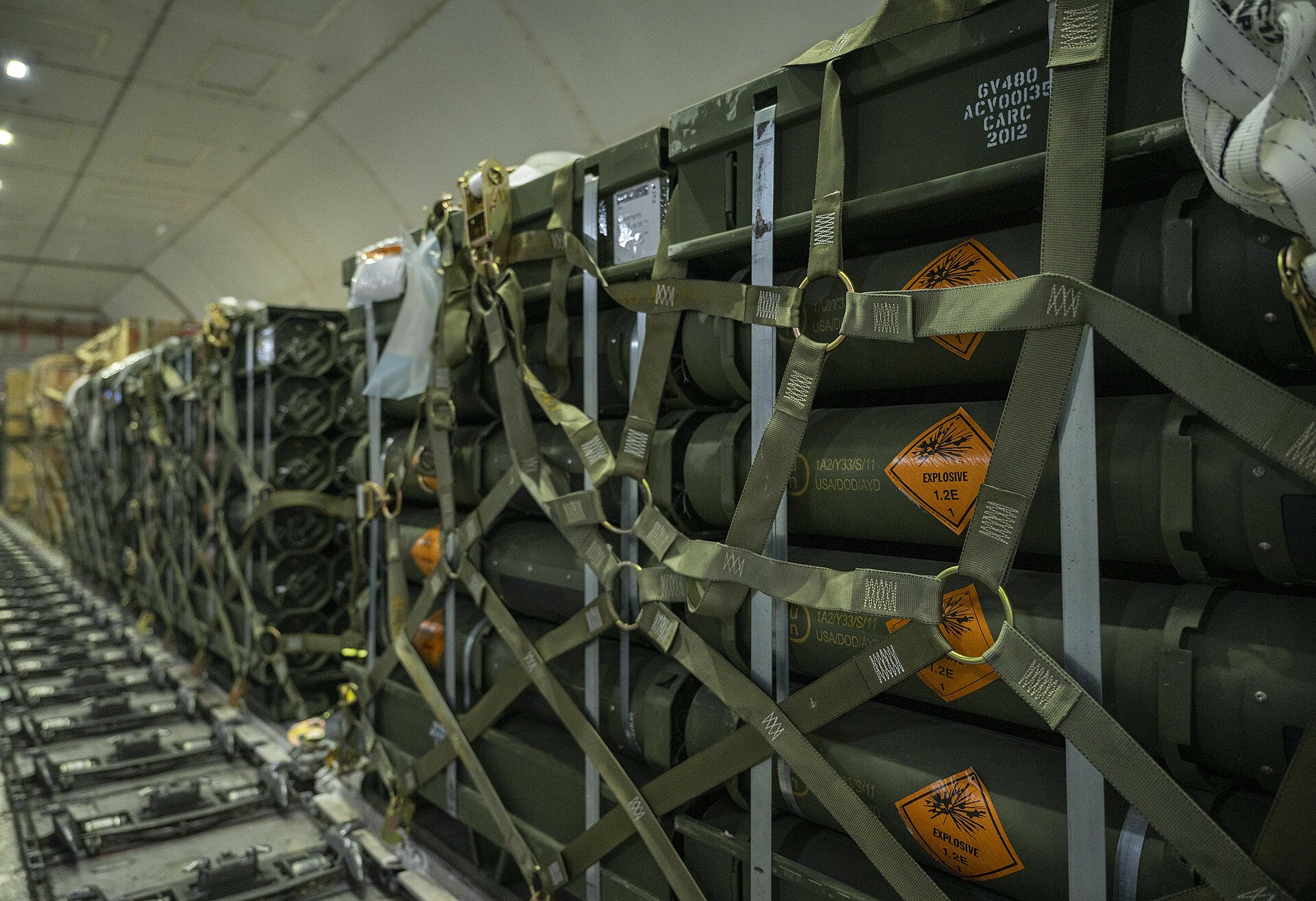 A pallet of defence equipment strapped down inside a transport aircraft